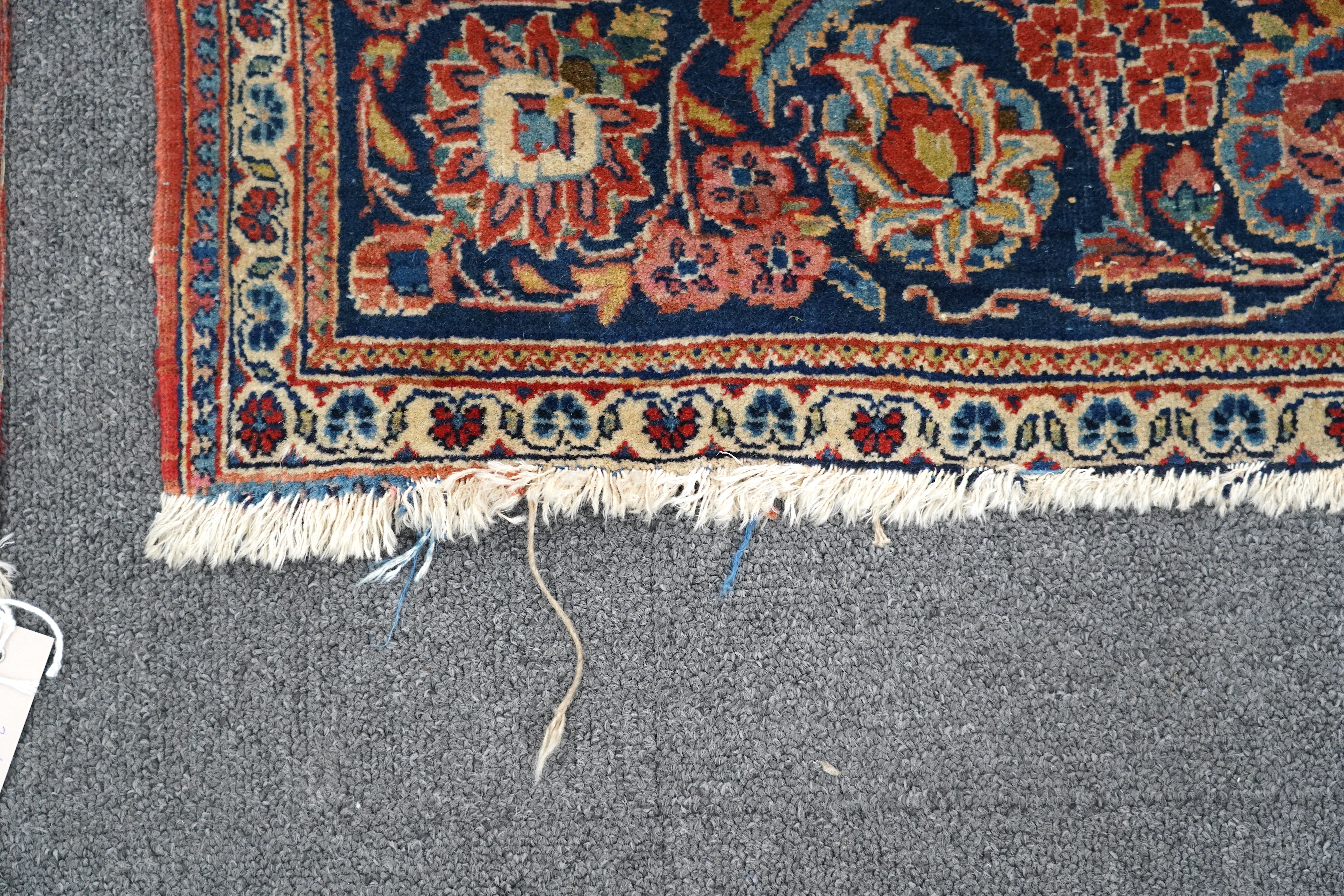 A pair of antique Tabriz brick red ground rugs, 200 x 136cm. Condition - fair